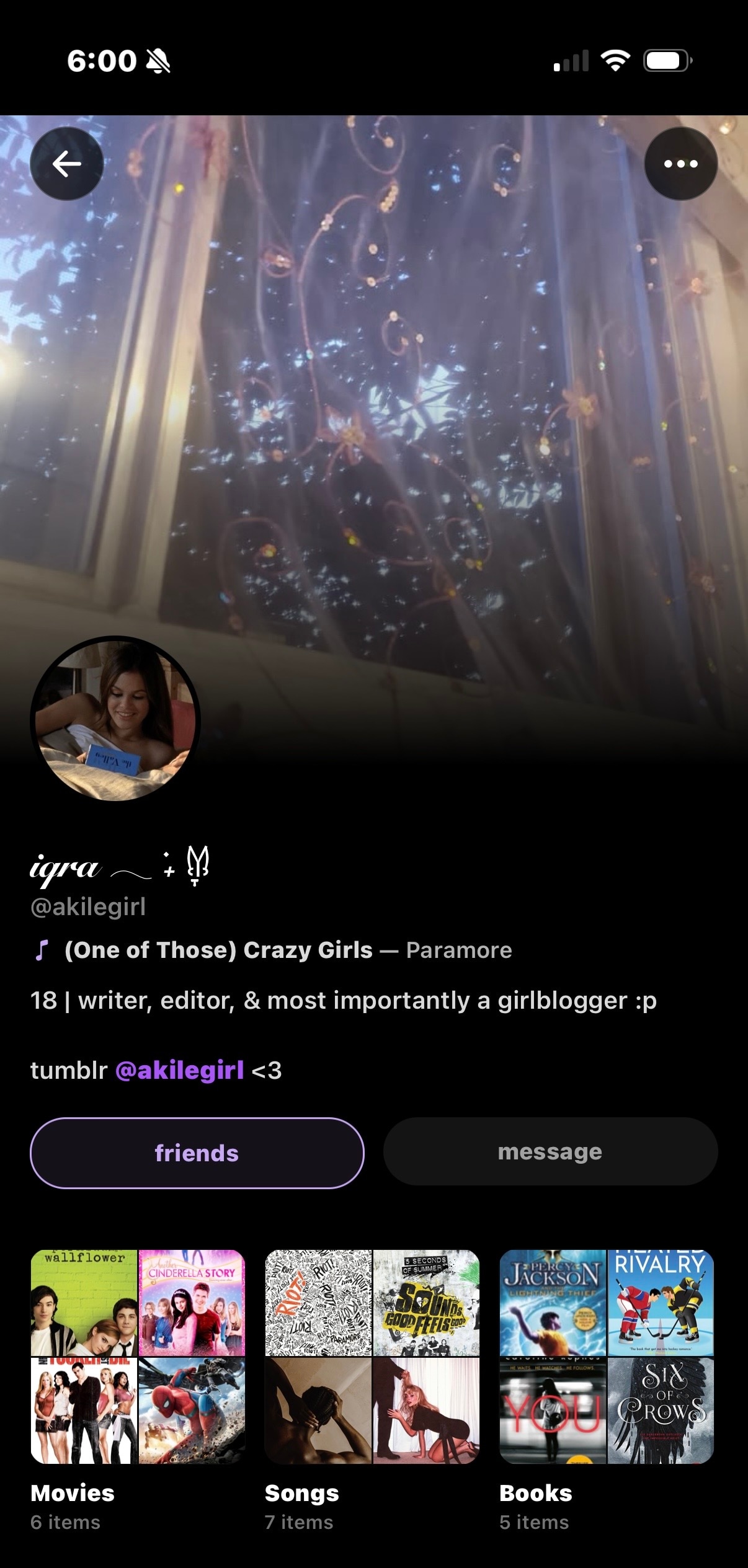 Iqra's Sharespot profile — fairy-light bedroom header, Paramore pinned, shelves of movies, songs, and books.